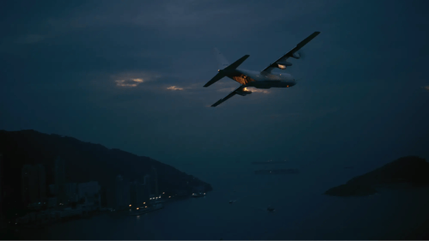 Still frame of plane flying away from Hong Kong in The Dark Knight movie. 