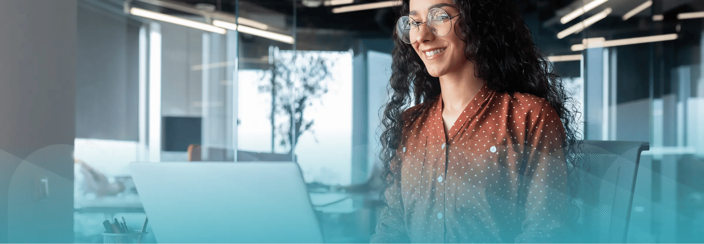 Employee completing new employee orientation on computer. Teal filter on top of image.