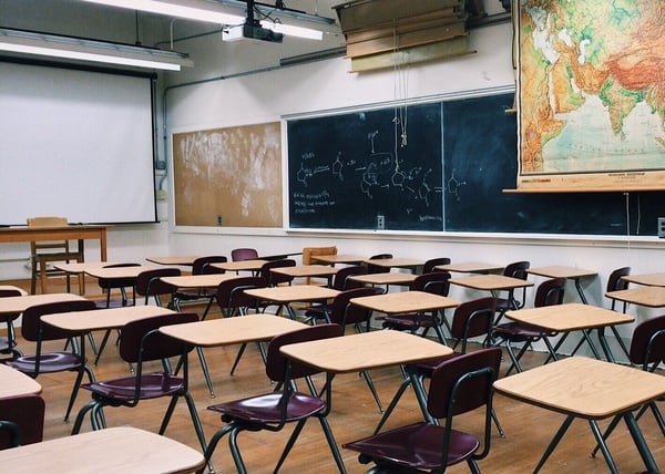 A traditional classroom with rows of desks and chairs.