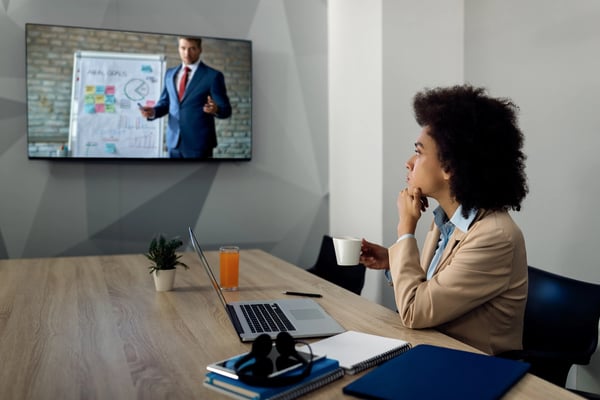 Employee watching interactive video in office.