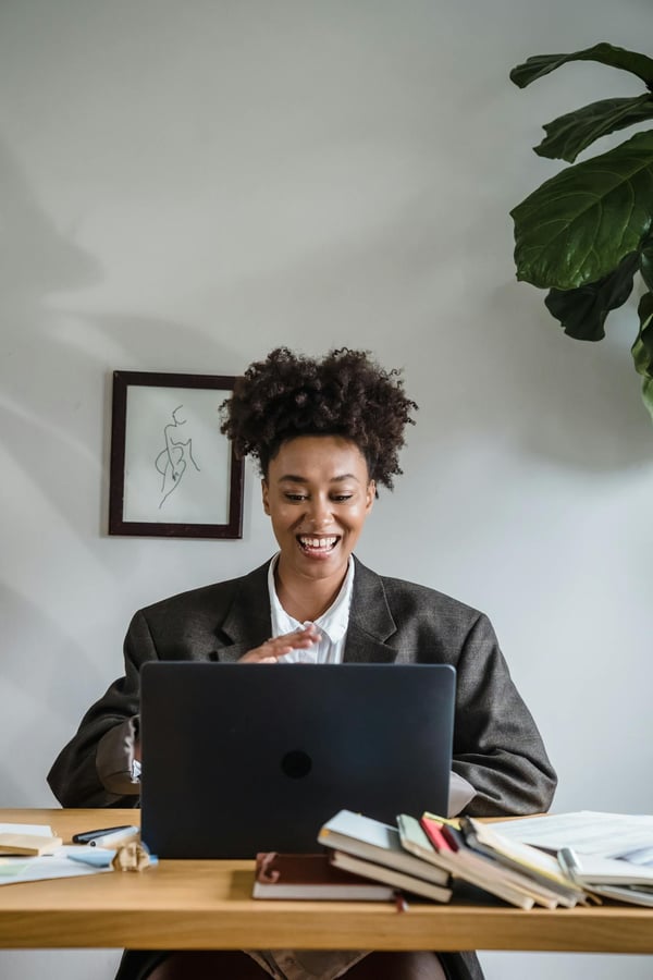 Business woman smiling while video learning.