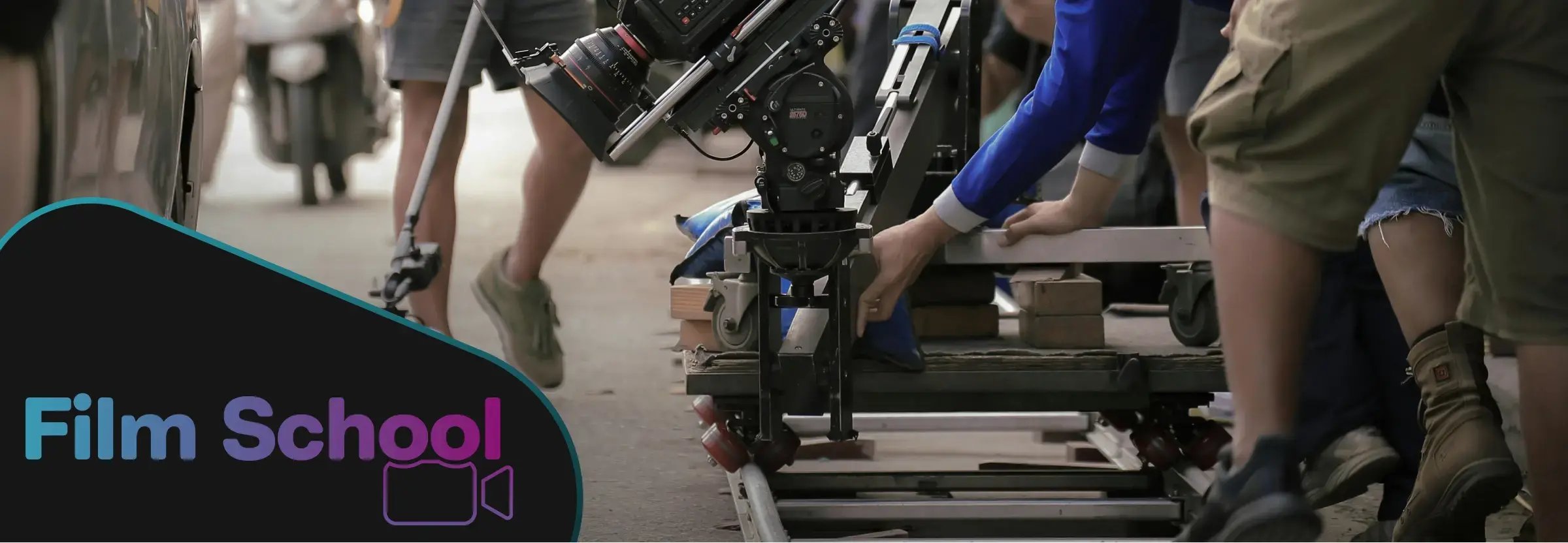 Dolly shot being captured on studio set. WeVideo Film School logo in left corner of image. 