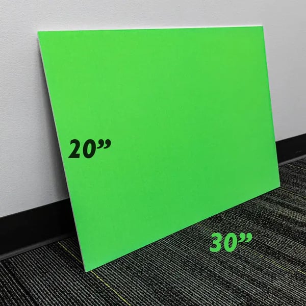 Green 20" by 30" foam board resting against a wall.