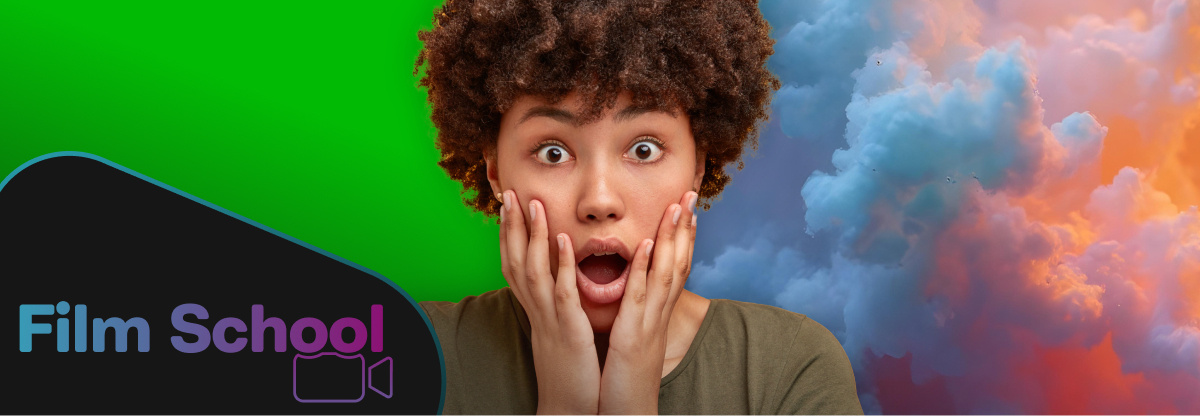 Woman with surprised facial expression in front of half of a green screen, half cloudy sky and WeVideo's Film School logo in bottom left corner.