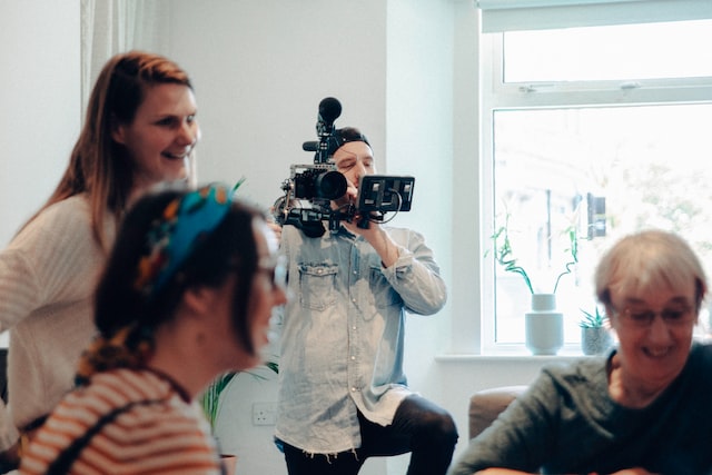 Man shooting footage of people talking