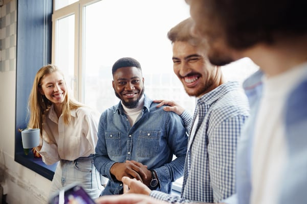 Smiling employees standing at a window and talking