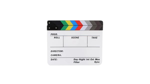 Whiteboard clapperboard with rainbow striped pattern on top.