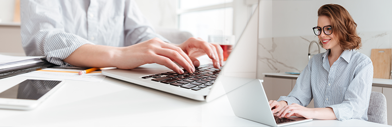 Split-screen of woman on computer. One from angle, and second of close-up on hands typing.